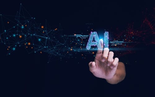 Digital styling with a hand touching the letters "AI"