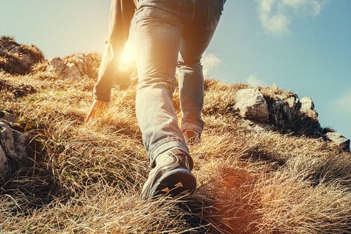 Person climbing a steep hill.