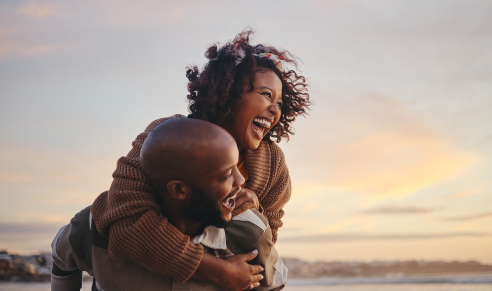 Happy Black Couple spending their vacation on the beach.