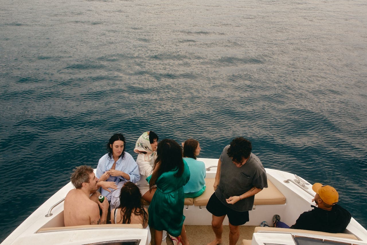 People sitting and talking in the rear of a boat